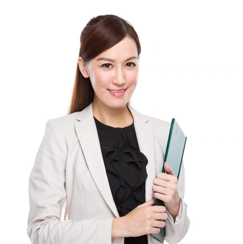 Asian businesswoman holding a clipboard.