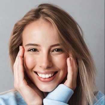 Smiling woman with light hair.