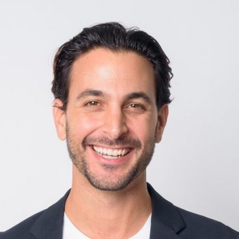 Smiling man with dark hair.
