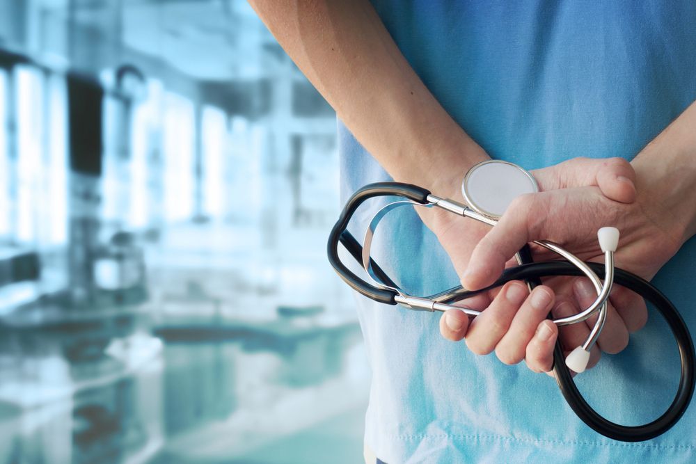 Medical professional holding a stethoscope.