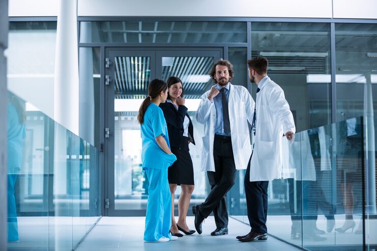 Medical staff talking in hallway.