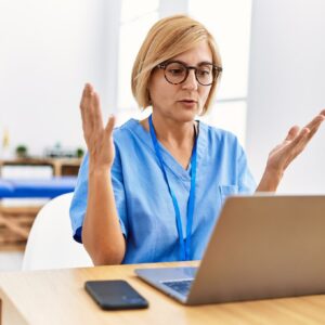 Medical professional using laptop computer.