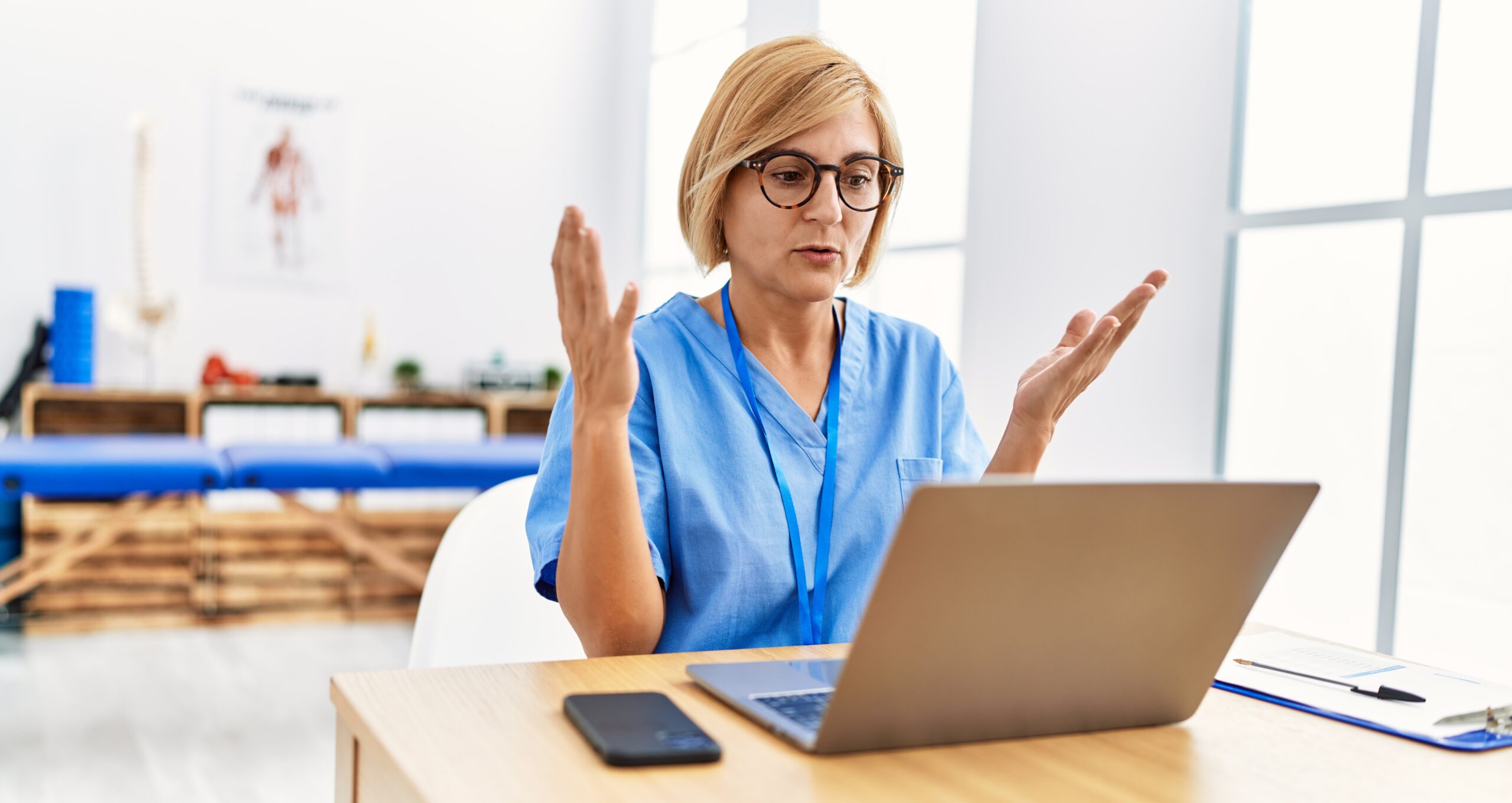 Medical professional using laptop computer.