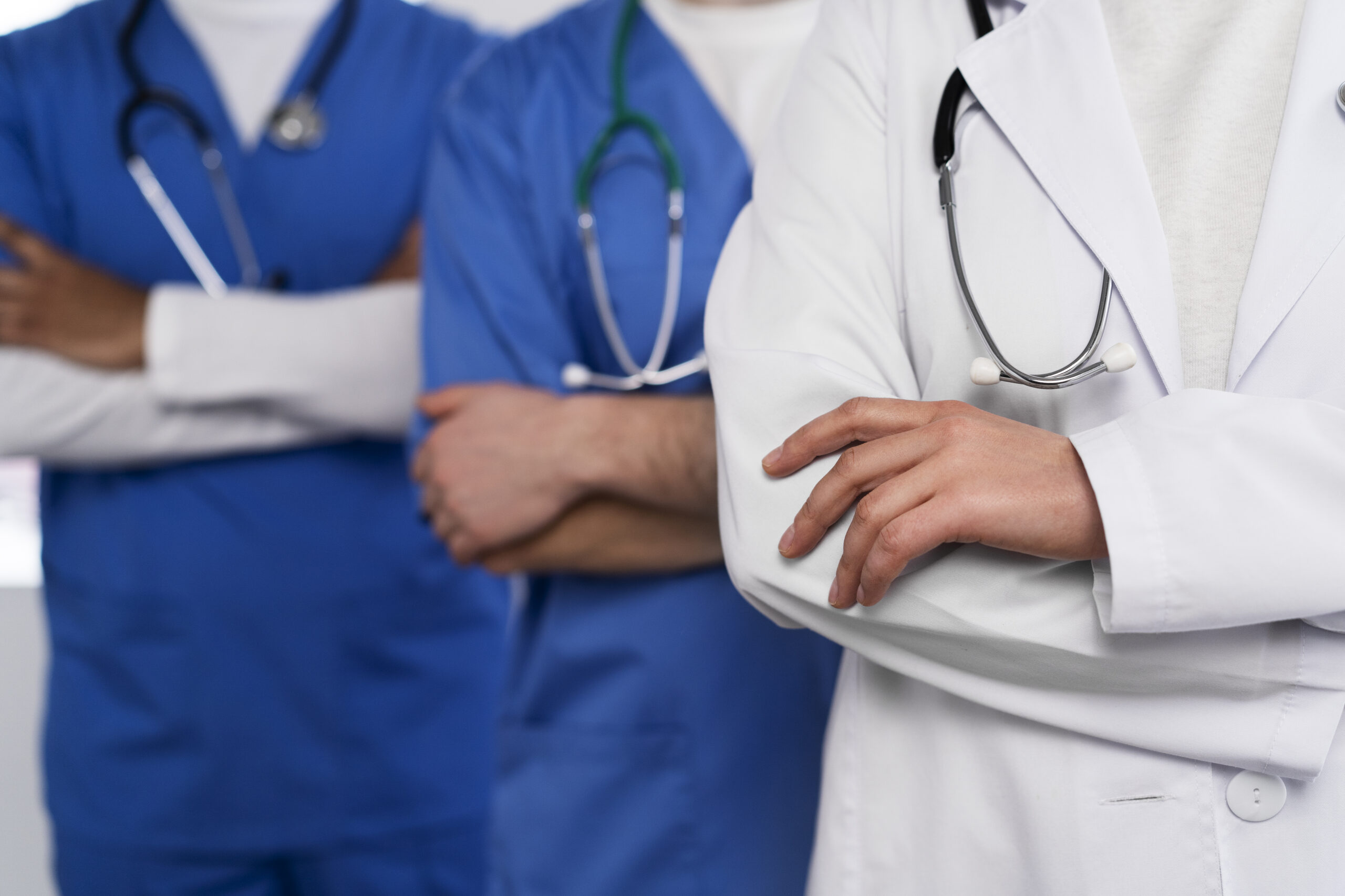 Medical professionals in scrubs and coats.